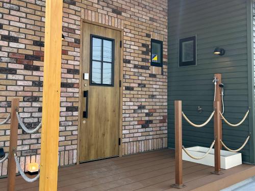 a wooden door on a brick building with ropes at nyans - Vacation STAY 60127v in Matsue