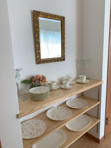 a shelf with plates and a mirror on a wall at Calm Enoshima 102 - Vacation STAY 61941v in Kamakura