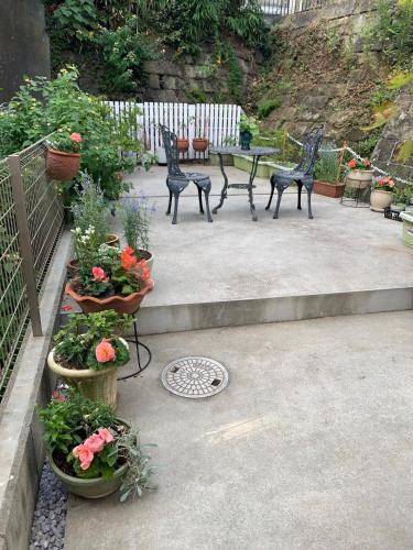 a patio with two chairs and a table and flowers at Calm Enoshima 102 - Vacation STAY 61941v in Kamakura