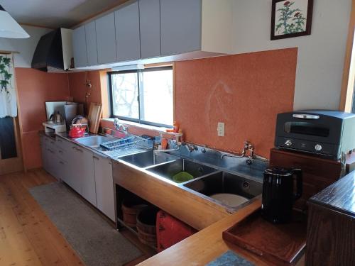 a kitchen with a stainless steel sink and a window at Kazeoka Sakuma - Vacation STAY 63930v in Iiyama