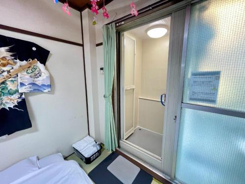 a small room with a shower and a glass door at Shobi Building 2 208 - Vacation STAY 16685 in Tokyo