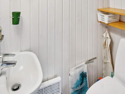 a bathroom with a white sink and a toilet at 7 person holiday home in Kolind-By Traum in Kolind