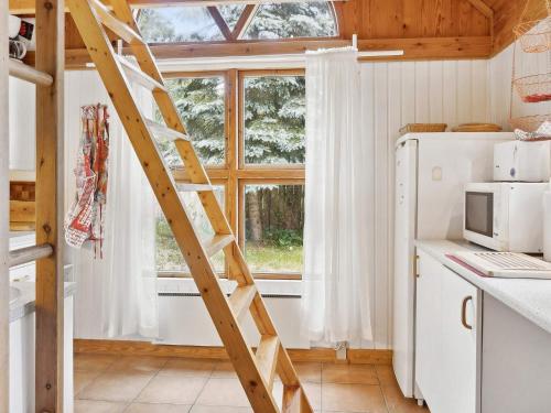 a wooden ladder in a kitchen with a window at 7 person holiday home in Kolind-By Traum in Kolind