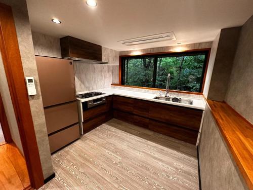 a small kitchen with a sink and a window at The No,10 Forest Haven Villa - Vacation STAY 67009v in Tatsutori