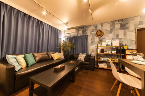 a living room with a couch and a table at Gajumaru no niwa - Itoman - Vacation STAY 16759 in Itoman