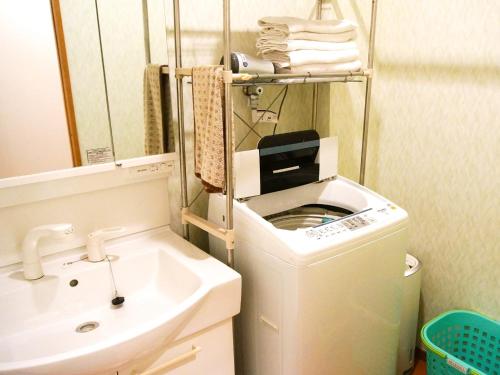 a bathroom with a washing machine and a sink at Minshuku Kunya - Vacation STAY 70182v in Fukai