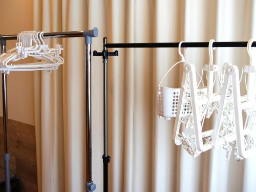 a black towel rack with white baskets in front of a curtain at Minshuku Kunya - Vacation STAY 70182v in Fukai