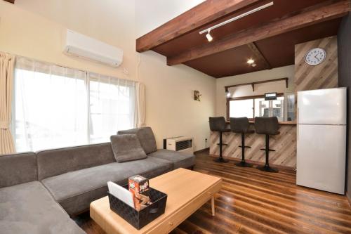 a living room with a couch and a refrigerator at Sapporo - House - Vacation STAY 16825 in Sapporo