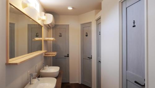 a bathroom with a sink and a toilet and a mirror at CAMP & BEER BEERBELLY ISESHIMA - Vacation STAY 82905v in Shima