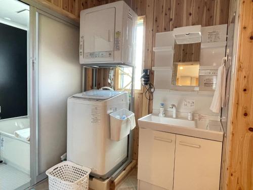 a small kitchen with a refrigerator and a sink at Agrito Island Time - Vacation STAY 84454v in Imabari