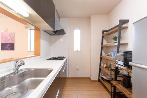 a kitchen with a sink and a stove at Genan no Sato - Vacation STAY 76405v in Odawara