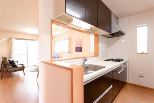 a kitchen with a sink and a stove at Genan no Sato - Vacation STAY 76405v in Odawara