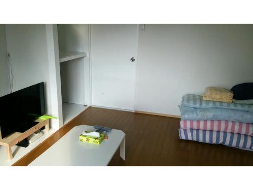 a living room with a couch and a coffee table at OYADO YAMASASHI - Vacation STAY 16886 in Ishigaki Island