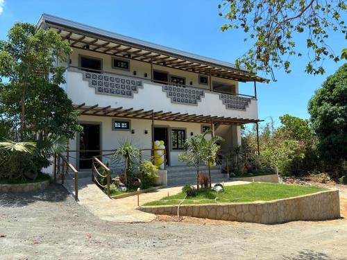 a house in the middle of a yard at Virgin River Resort Villas in Bolinao