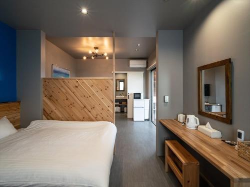a bedroom with a large bed and a mirror at Coteji Do - Vacation STAY 78358v in Ishigaki Island