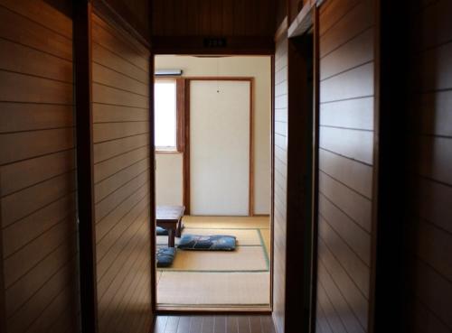 a room with a door leading to a room with a bed at Mihamakan, Izu Oshima - Vacation STAY 89847v in Oshima