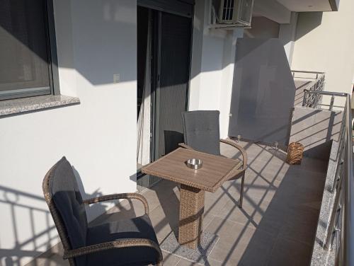 a patio with a table and chairs on a balcony at Poly s home3 in Ioannina