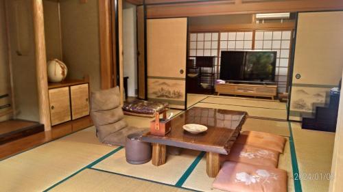 a living room with a coffee table and a tv at Tadoan - Vacation STAY 16923 in Nagashima