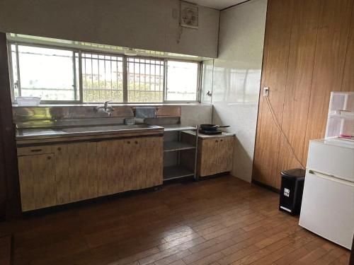 a kitchen with a sink and a refrigerator at Alupie m - Vacation STAY 97351v in Arao