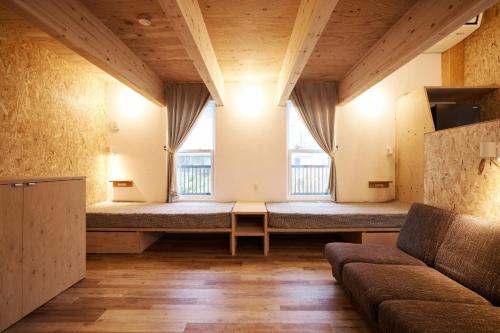 a room with a couch and two windows at Bungalow One - Vacation STAY 98273v in Kamogawa