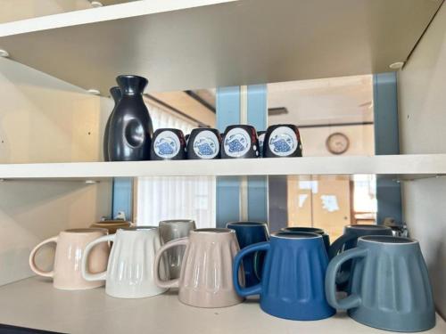 a row of blue and white ceramics on shelves at Ocean villa Oarai - Vacation STAY 94315v in Oarai
