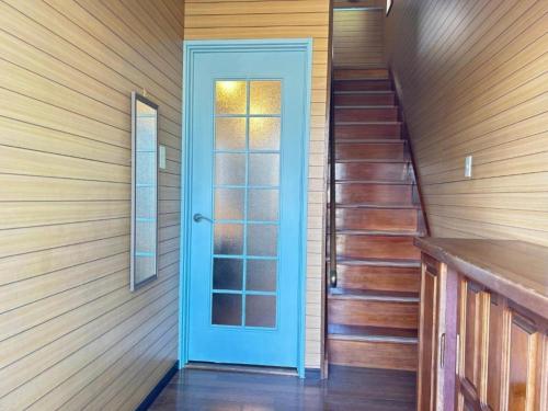 a hallway with a blue door and stairs at Ocean villa Oarai - Vacation STAY 94315v in Oarai