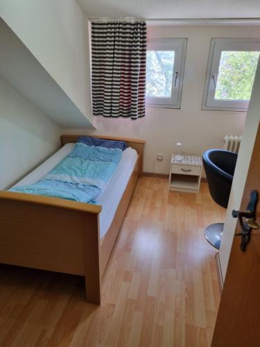 a small bedroom with a bed and a bathroom at Famile Hotel Kameleon in Olsberg