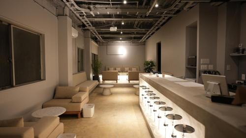 a room with couches and tables in a room at Guesthouse s,e,n - Vacation STAY 99404v in Koriyama