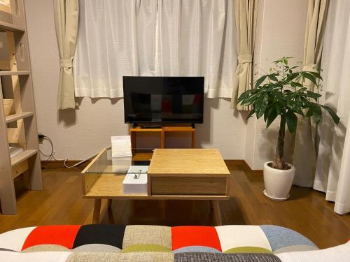 a living room with a tv and a coffee table at Rosemary Mansion 203 - Vacation STAY 00077v in Kagoshima