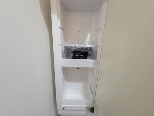 an empty refrigerator with its door open in a room at Earlville - Vacation STAY 16987 in Hiroshima