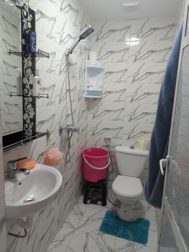 a bathroom with a white toilet and a sink at Guesthouse Skhirat in Skhirat