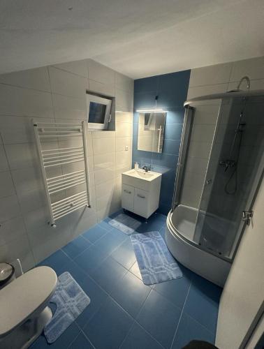 a bathroom with a toilet and a sink and a shower at Azuga Home in Azuga