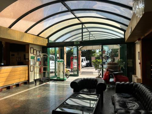 a building with a vaulted ceiling with couches and chairs at Da Mariuccia in Robecchetto con Induno