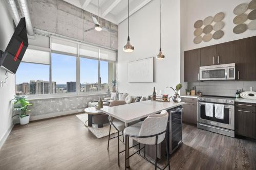 a kitchen with a table and some chairs in a room at The Aura Penthouse in Atlanta