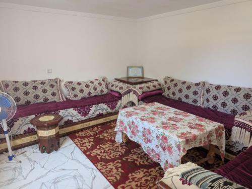 a living room with a couch and a table at Guesthouse Skhirat in Skhirat