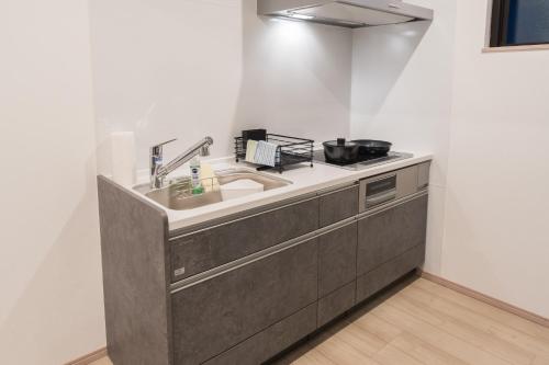 a kitchen with a sink and a counter at Yufunoshizuku -Asagiri-Yunagi-Akatsuki- - Vacation STAY 01373v in Yufuin