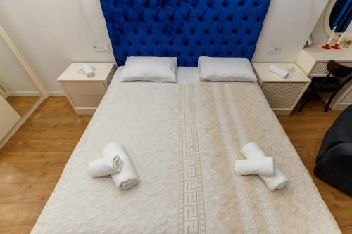 a bedroom with a large bed with towels on it at Luxury 2-Bedroom 2-Bath Apartment in City Center in Yerevan