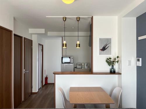 a dining room and kitchen with a table and chairs at Kin-Con-Kan - Vacation STAY 05400v in Nanjo