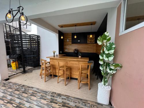 a dining room with a wooden table and chairs at Sinza Hiddenout in Dar es Salaam