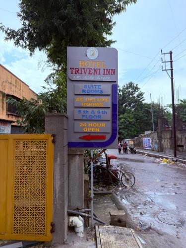 a sign for a hotel treatment inn on a street at Hotel Triveni Inn Ambernath in Ambernath