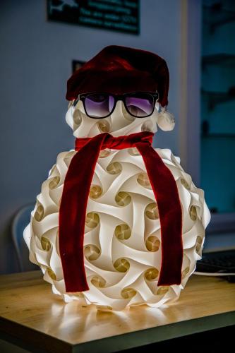 a cake with a santa hat and sunglasses on it at Maison Blanche DK in Puducherry