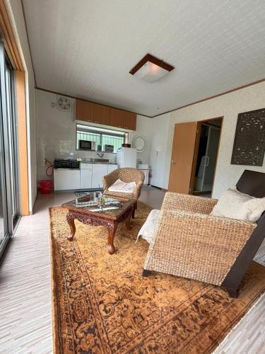 a living room with a couch and a coffee table at Bamboo Camp Site "Isumi Genji Firefly Village" - Vacation STAY 08176v in Ōtaki