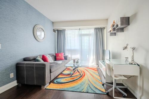 a living room with a couch and a table at Modern 2Bd 2Ba Skyscraper Free parking in Toronto