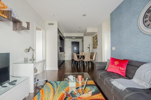 a living room with a couch and a table at Modern 2Bd 2Ba Skyscraper Free parking in Toronto