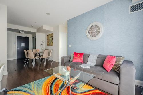 a living room with a couch and a table at Modern 2Bd 2Ba Skyscraper Free parking in Toronto