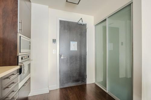 a bathroom with a glass door in a kitchen at Modern 2Bd 2Ba Skyscraper Free parking in Toronto