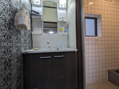 a small bathroom with a sink and a mirror at Momijian Tofukuji Temple - Vacation STAY 19724v in Kyoto