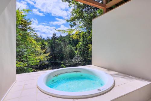 a bath tub in a room with a view at Pension Yumi - Vacation STAY 20865v in Nikko
