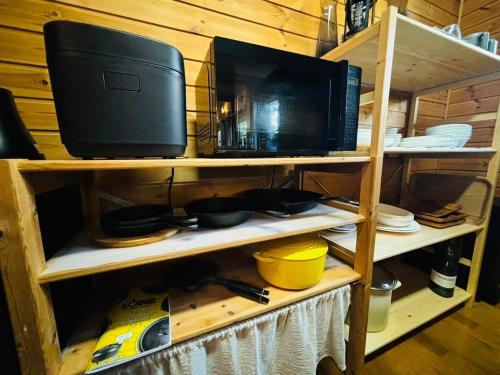 a shelf with a microwave and a television on it at KOZUKA House - Vacation STAY 17813v in Kamogawa