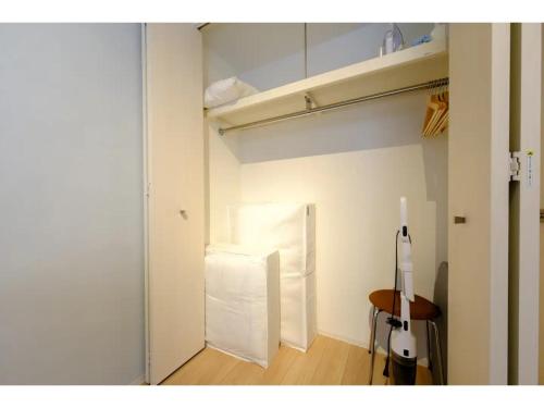 a room with a refrigerator and a table in it at ZOOM Esaka Park - Vacation STAY 17114 in Suita